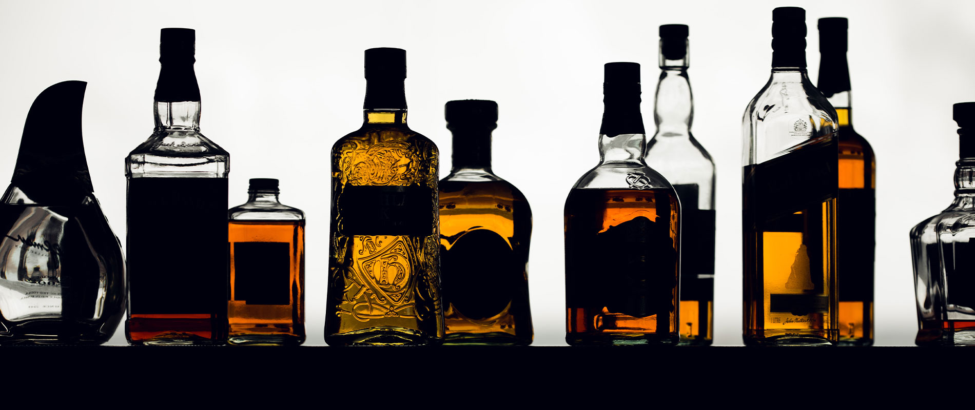 image row of glass liquor bottles
